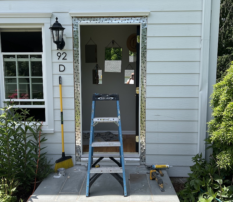 Remove the old door and apply flashing tape